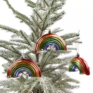 Rainbow Christmas hanging ornaments with colorful electroplating on snowy pine branches