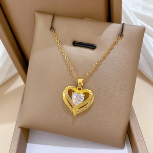 Macro view of gold plated heart necklace featuring love you forever engraving