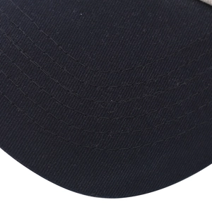 Macro shot of navy washed cotton baseball cap brim with four rows of reinforced stitching
