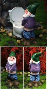 Detail view of funny garden gnome ornament sitting on a toilet with green hat and resin base