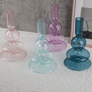 Set of four colorful borosilicate glass candle holders in various geometric shapes