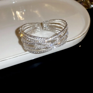 Close-up of sparkling multilayer rhinestone bracelet on white ceramic display tray