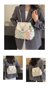 Detailed multi-angle views of a colorful woven backpack with metal chain and flower charm