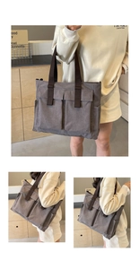 Detailed view of dark grey canvas tote bag with brown straps and large front pockets