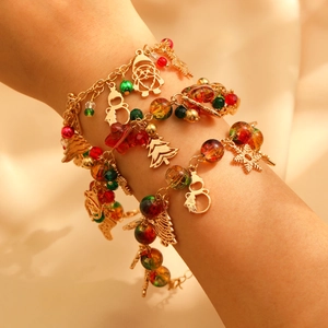 Christmas beaded bracelet set with Santa and snowflake charms on a golden chain