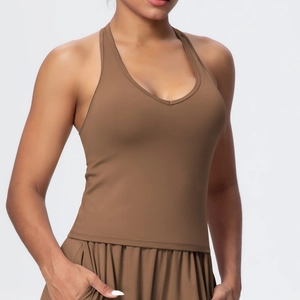 Detail of V-neck sports bra featuring wide shoulder straps and soft matte texture
