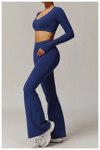 Detail of high-waisted flared yoga pants with thumbhole long sleeve top in navy blue
