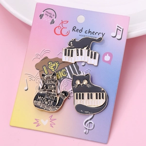 Three cute black cat enamel pins with music theme on illustrated backing card