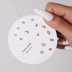 Close-up of silver stud earring set with pearls and crystals on fashion jewelry card