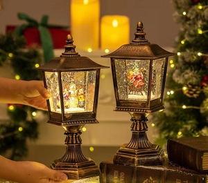 Close-up of vintage bronze Christmas street lamp decor with Santa and snowman inside