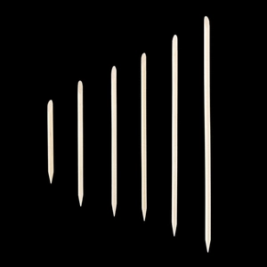 Macro shot of various lengths of professional wooden nail sticks with dual ends for manicure