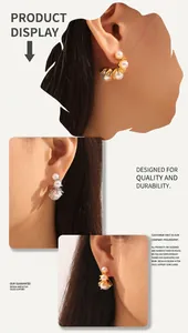Detailed view of gold and silver claw earrings featuring multiple white pearls on model