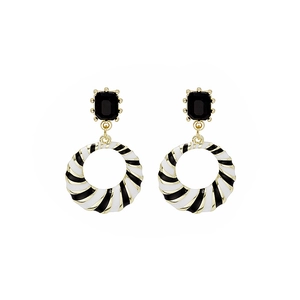 Close-up of vintage black and white striped enamel earrings with black gemstone inlays