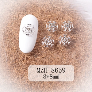 Silver alloy snowflake nail charm with center rhinestone detail on white base