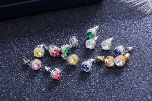 Detailed view of colorful round halo zircon earrings in various sparkling gemstone shades