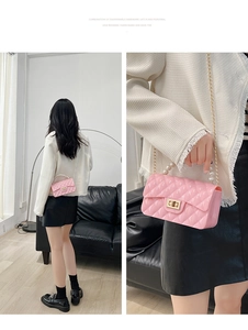 Pink rhombic jelly bag featuring faux pearl handle and gold chain strap detail