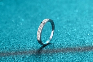 Close-up of minimalist S925 silver band set with shimmering moissanite stones