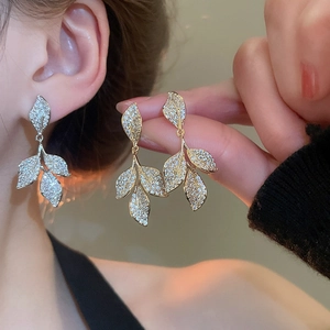 Detailed view of silver zircon leaf tassel earrings with sparkling pave-set stones
