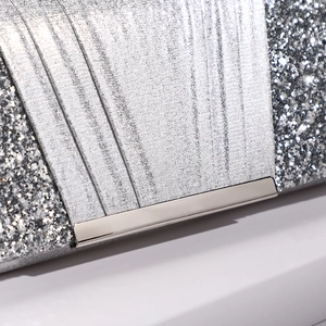Sparkly silver sequin evening clutch bag with glossy metal trim and elegant texture