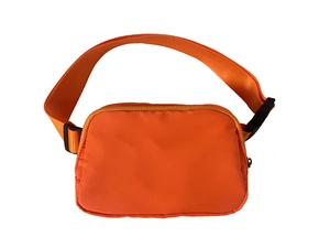 Detail of water-resistant orange sports waist bag with adjustable strap and buckle