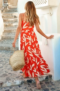 Back view of bohemian tiered orange floral maxi dress with thin straps and open back