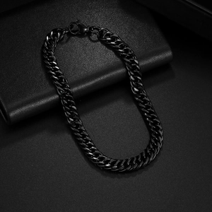 Minimalist black metal Cuban chain bracelet with lobster clasp on leather texture