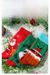 Detailed view of festive cotton Christmas socks with Santa Claus and gingerbread patterns