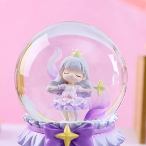 Close-up of a rotating musical snow globe with a girl in a purple dress and yellow crown