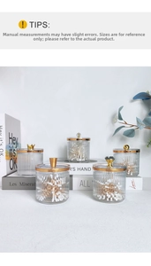 Detailed view of fluted glass jars with gold handles for cotton swabs and toothpicks