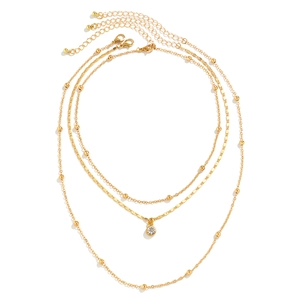 Three-layer gold chain necklace featuring spherical beads and a sparkling zircon pendant