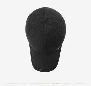 Top down view of dark grey wool blend flat cap with structured six panel design and brim