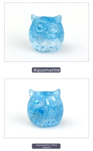 Detailed view of owl resin figurines in aquamarine blue with sparkling glitter finish