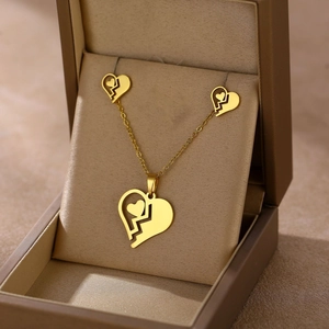 Polished gold stainless steel jewelry set with crushed heart necklace and earrings in a box