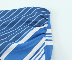Close-up of blue and white striped linen fabric texture on a backless tube top