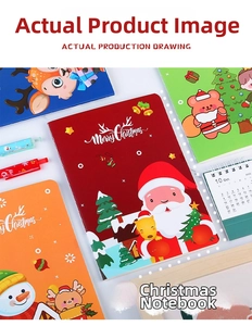 Detail view of stacked A5 Christmas notebooks with cute cartoon reindeer and Santa illustrations