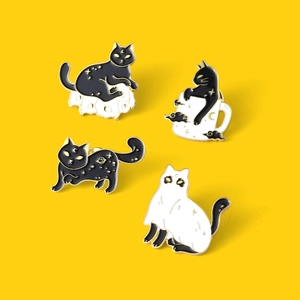 Detailed view of four fantasy cat enamel pins on vibrant yellow background