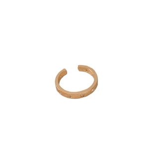 Golden open star ring with brushed finish and zircon detail on white background