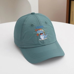 Close-up of kids' blue baseball cap featuring dinosaur embroidery and breathable mesh holes
