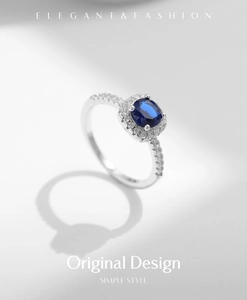 Macro detail of S925 sterling silver ring with square blue sapphire and halo setting