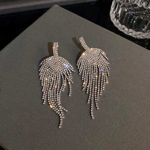 Close-up of sparkling rhinestone leaf tassel earrings with silver feather design detailing