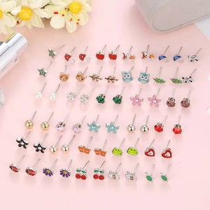 30 pairs of colorful animal and flower plastic stud earrings set on pink background