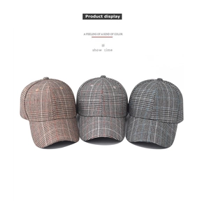 Three embroidered plaid baseball caps in red, black, and blue patterns on white background
