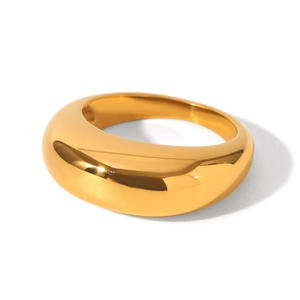 Close-up of polished gold dome ring with smooth surface and mirror-like metallic shine