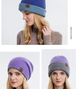 Detail view of thickened knitted beanies with color-blocking and leather mountain logo patch