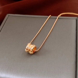 Macro shot of 18k gold plated pendant necklace with zircon detail on red satin