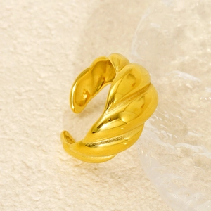 Polished 18k gold plated stainless steel spiral twisted dome ring on textile background