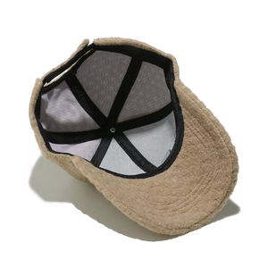 Detail view of the warm camel plush baseball cap showing interior lining and adjustable strap