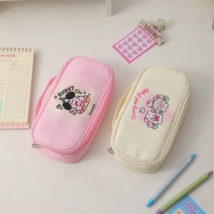 Detail view of large capacity fabric pencil pouches with cute puppy illustrations and handles