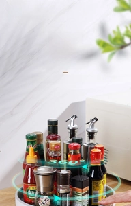 Close-up of a white 360 rotating lazy susan organizer holding various spice bottles