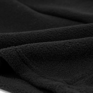 Macro detail of high-density black fleece fabric texture for thermal winter sports gear